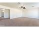 Bonus room with neutral carpet, ceiling fan, and access to additional rooms at 30263 N Bobcat Way, San Tan Valley, AZ 85143