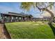Expansive clubhouse with a covered patio and meticulously manicured lawn providing a welcoming outdoor space at 30263 N Bobcat Way, San Tan Valley, AZ 85143