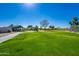 Lush green community park with a playground and gazebo creating a vibrant and inviting recreational area at 30263 N Bobcat Way, San Tan Valley, AZ 85143