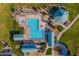 Overhead view of a luxurious community pool, playground, and beautifully landscaped green spaces at 30263 N Bobcat Way, San Tan Valley, AZ 85143