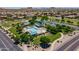 Aerial view of a community park featuring a pool, picnic ramadas, and beautiful mountain views at 30263 N Bobcat Way, San Tan Valley, AZ 85143