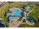Aerial view of a community pool with ample seating, playground, and green spaces for outdoor recreation at 30263 N Bobcat Way, San Tan Valley, AZ 85143
