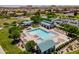 Overhead shot of a community pool, lounging areas, and lush landscaping in a Gathering-friendly community at 30263 N Bobcat Way, San Tan Valley, AZ 85143