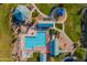 Aerial view of a community pool with lounging areas, a playground, and picnic shelters at 30263 N Bobcat Way, San Tan Valley, AZ 85143
