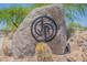 Community sign made of desert rock featuring the JR logo, with native cacti and landscaping at 30263 N Bobcat Way, San Tan Valley, AZ 85143