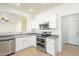 Bright kitchen featuring white cabinets, stainless steel appliances, tile flooring and an open floor plan at 30263 N Bobcat Way, San Tan Valley, AZ 85143