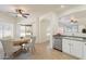 Bright eat-in kitchen features a stainless steel dishwasher, tile floors, neutral paint, and lots of natural light at 30263 N Bobcat Way, San Tan Valley, AZ 85143