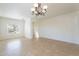 Bright living room featuring tile floors, a window, an arched doorway, and a chandelier at 30263 N Bobcat Way, San Tan Valley, AZ 85143