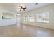 Spacious living room featuring tile floors, neutral walls and lots of natural light from the many windows at 30263 N Bobcat Way, San Tan Valley, AZ 85143
