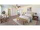 The spacious main bedroom has a ceiling fan, neutral paint, ensuite bathroom and walk-in closet at 30263 N Bobcat Way, San Tan Valley, AZ 85143