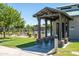 The pool entrance features stone accents, covered entry, and lush landscaping enhancing community appeal at 30263 N Bobcat Way, San Tan Valley, AZ 85143