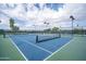 Ground-level view of community tennis courts, showcasing the well-maintained playing surface and net at 30263 N Bobcat Way, San Tan Valley, AZ 85143