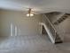 Open living room featuring neutral paint, plush carpet, a ceiling fan, and a staircase at 3107 W Loma Ln, Phoenix, AZ 85051