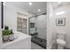 Modern bathroom features a sleek glass shower door, white marble tile, and open shelving at 3117 E Sweetwater Ave, Phoenix, AZ 85032