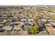 An aerial view showcases a neighborhood featuring single-story homes with lush greenery and some homes with solar panels at 3138 W Glenrosa Ave, Phoenix, AZ 85017