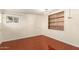 Cozy bedroom featuring wood paneling and a built-in bookshelf at 3138 W Glenrosa Ave, Phoenix, AZ 85017