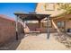 Backyard area with a gazebo featuring chairs, a table and brick pavers for outdoor relaxation at 317 W Settlers Trl, Casa Grande, AZ 85122