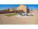 Landscaped backyard featuring a basketball court, and a cozy fire pit with ample seating at 317 W Settlers Trl, Casa Grande, AZ 85122