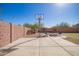 Spacious backyard with a basketball hoop and outdoor seating area, perfect for recreation at 317 W Settlers Trl, Casa Grande, AZ 85122