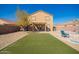 Large backyard with a basketball hoop, artificial turf, and cozy seating, perfect for outdoor gatherings at 317 W Settlers Trl, Casa Grande, AZ 85122