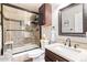 Modern bathroom with a glass enclosed shower, a dark wood vanity and lots of natural light at 317 W Settlers Trl, Casa Grande, AZ 85122