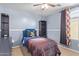 This bedroom includes a sports theme, ceiling fan, and open window for ample light at 317 W Settlers Trl, Casa Grande, AZ 85122