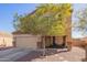 Two story home with an attached garage, desert landscaping and a covered porch seating area at 317 W Settlers Trl, Casa Grande, AZ 85122