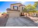 Two story home with an attached garage, desert landscaping and a covered porch seating area at 317 W Settlers Trl, Casa Grande, AZ 85122