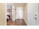 Hallway with wood floors leading to the front door, bedroom and additional rooms at 317 W Settlers Trl, Casa Grande, AZ 85122