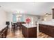 Open kitchen and dining area with island, granite counters, stainless appliances, and natural light at 317 W Settlers Trl, Casa Grande, AZ 85122