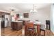 Kitchen and dining area featuring stainless steel appliances, island, and stylish backsplash at 317 W Settlers Trl, Casa Grande, AZ 85122