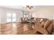 Cozy living room with wood-look tile flooring, ceiling fan, and comfortable seating arrangement at 317 W Settlers Trl, Casa Grande, AZ 85122
