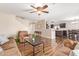 Open-concept living room with staircase, wood-look flooring, and comfortable sofa and armchair at 317 W Settlers Trl, Casa Grande, AZ 85122