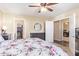 This main bedroom includes a ceiling fan, a round mirror, and includes views to the walk-in closet and office at 317 W Settlers Trl, Casa Grande, AZ 85122