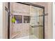 Walk-in shower with custom tile work, a built-in bench, glass doors, and designer shower head at 317 W Settlers Trl, Casa Grande, AZ 85122