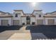 Inviting condo exterior featuring a tile roof, attached garages, and well-maintained landscaping at 3236 E Chandler Blvd # 2067, Phoenix, AZ 85048