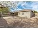Large backyard with a covered patio, desert landscaping, and mature trees, perfect for outdoor activities at 39559 N Prairie Ln, Anthem, AZ 85086