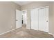Bright bedroom with plush carpeting, double-door closet and doorway access to other rooms at 39559 N Prairie Ln, Anthem, AZ 85086