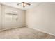 Bright carpeted bedroom with a large window and a ceiling fan at 39559 N Prairie Ln, Anthem, AZ 85086