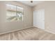 Well-lit bedroom with plush carpeting, double-door closet, and a bright window providing outdoor views at 39559 N Prairie Ln, Anthem, AZ 85086