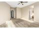 Spacious carpeted bedroom with ceiling fan, and doors to the bathroom and walk-in closet at 39559 N Prairie Ln, Anthem, AZ 85086