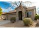 Charming single-story home with a well-maintained lawn, desert landscaping, and attached garage at 39559 N Prairie Ln, Anthem, AZ 85086