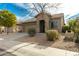 Charming home with a two-car garage, desert landscaping and beautiful desert plants at 39559 N Prairie Ln, Anthem, AZ 85086