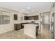Modern kitchen features dark wood cabinets, an island, stainless appliances, and hardwood floors at 39559 N Prairie Ln, Anthem, AZ 85086