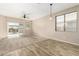 Living area featuring tile and carpet flooring, sliding glass doors, and modern light fixture at 39559 N Prairie Ln, Anthem, AZ 85086