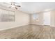 Bright and airy living room showcasing wood-look tile floors, neutral paint, and ample natural light at 39559 N Prairie Ln, Anthem, AZ 85086