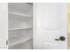 A pantry with multiple shelves provides ample storage space next to a white door at 39559 N Prairie Ln, Anthem, AZ 85086