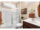 A cozy bathroom featuring a white bathtub, shower, and white toilet next to a wooden cabinet and sink at 42072 W Dorsey Dr, Maricopa, AZ 85138