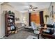 A cozy room with a neutral color scheme and a ceiling fan over the sofa, chairs, and shelves at 42072 W Dorsey Dr, Maricopa, AZ 85138