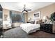 Serene main bedroom features neutral tones, ceiling fan, a big window, and comfortable furniture at 42072 W Dorsey Dr, Maricopa, AZ 85138